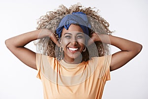 Close-up healthy and energized, enthusiastic attractive african-american curly-haired blond woman in headband, orange t