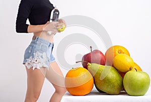 Close up of healthy girl with perfect buttocks and thighs. Slim body of young woman. Fruits diet.