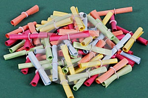 a close up of a heap from colorful tombola tickets are lying on a green ground