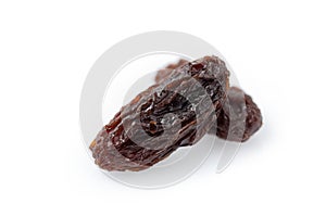 Close up of heap of dried raisins isolated on white