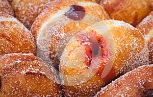 Close-up of a heap of jam-filled sugar-coated doughnuts