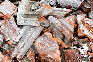 Close up of a heap of old, dirty broken roof tiles. Construction roofing industry background