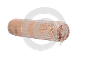 Close up heap of wooden dowel pins isolated on white