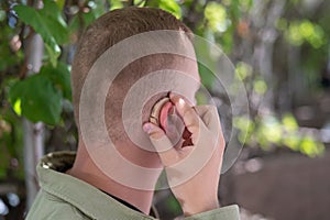 Close-up of a hearing aid on a man's ear.