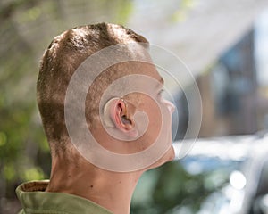 Close-up of a hearing aid on a man& x27;s ear.