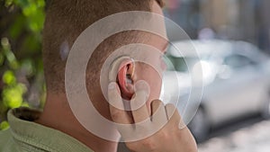 Close-up of a hearing aid on a man& x27;s ear.