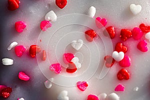 Close up of heart donut with tiny red heart sprinkles on top