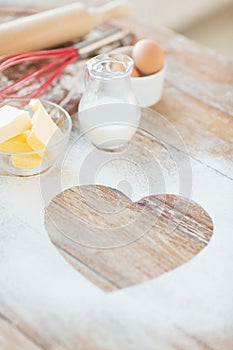 Close up of heart of flour on wooden table at home