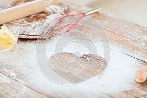 Close up of heart of flour on wooden table at home