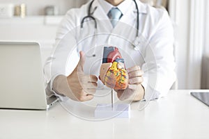 Close up of heart mockup with male doctor thumbs up gesture close to it