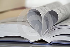 Close-up of heart shape from paper book