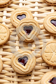 Close-up of heart-shaped cookies and strawberry jam, on a basket, for Valentine`s Day