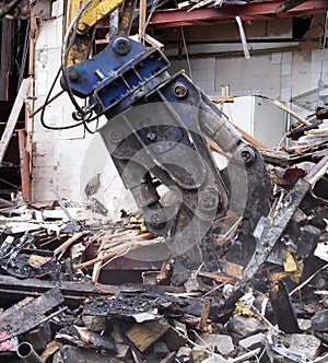 close up of a heavy demolition claw picking up rubble and debris on a construction site