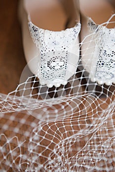 Detail of the Heels of a Pair of White Vintage Shoes Trimmed with Lace and Pearls. photo