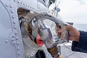Close up of the helicopter refueling operation onboard the navy ship