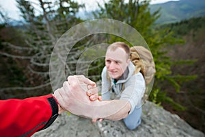 Close-up of helping hand, hiking help each other