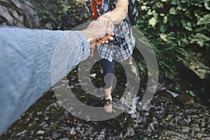 Close-up Of Helping Hand, Hiking Help Each Other. Focus On Hands. People Teamwork Hiking With Motivation And Inspiration. Wide ang