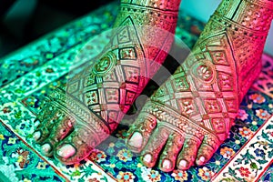 Close-up of henna-adorned legs with intricate designs photo