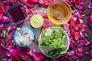 Close up of a herbal face pack consisting of Aloe Vera gel,honey,milk cream,lemon and rose with rose water and rose petals on wood