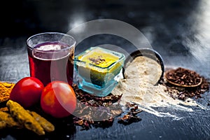 Close up of herbal face pack of tomato and turmeric with sandal wood,fuller`s earth or mulatni mitti or mulpani mitti on wooden su