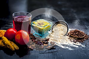 Close up of herbal face pack of tomato and turmeric with sandal wood,fuller`s earth or mulatni mitti or mulpani mitti on wooden su