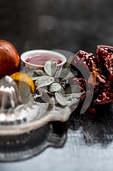 Close up of herbal and organic face pack of pomegranate with lemon juice on wooden surface for Sun tanning.