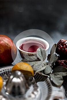 Close up of herbal and organic face pack of pomegranate with lemon juice on wooden surface for Sun tanning.