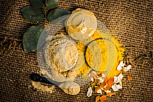 Close up of herbs`s powder and paste i.e mulpani mitti,fuller`s earth , dried orange peel and rose leaves with its extracted water photo