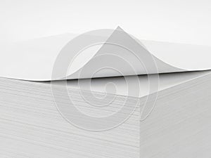 Stack of white paper with curled top sheet isolated on white background