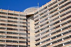 Close Up of High Rise Apartment Building Against Blue Sky