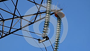 Close up of a high voltage power pylons against blue sky