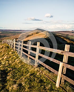 A close up of a hillside next to a wooden fence - Mam tor