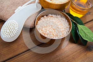 Close up of himalayan pink salt with brush on wood