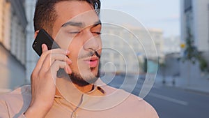 Close-up Hispanic Indian businessman bearded man talking mobile phone remote conversation distant talk answering call