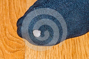 Close-up for hole in black sock