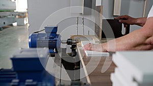 Close-up of a hole in a wood panel using a drill press. A drilling machine makes a hole in an MDF panel. About to