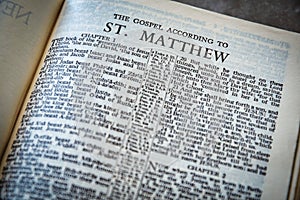 Close up of Holy Bible page, shallow depth of field with focus on book chapter, heading photo