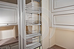 Close Up home interior. Kitchen - opened door with chrome furniture shelf. Wood and Chrome Material, Modern Design