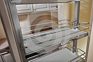 Close Up home interior. Kitchen - opened door with chrome furniture shelf. Wood and Chrome Material, Modern Design