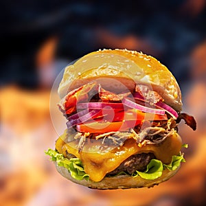 Close-up of home made burgers with fire flames.