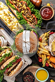 Close-up of home made tasty burger and hot dogs with fried chicken french fries. raditional American food. fast food