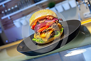 Close-up of home made tasty burgers on plate in restaurant.