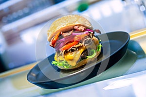 Close-up of home made tasty burgers on plate in restaurant.