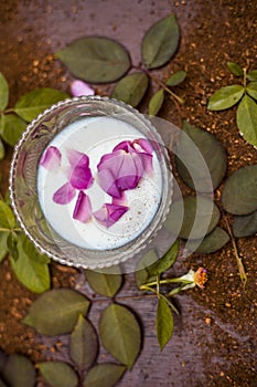 Close up of home remedy of scars or face pack to scars i.e. Sandal wood powder with milk and rose water on wooden surface with