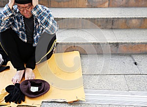 Close up homeless man sadness on walking street in the capital city.