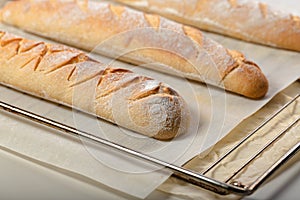 Close-up homemade fresh mouth-watering sourdough baguettes. Homebaked bread