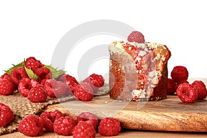 Close up homemade raspberry muffins with raspberries red fruits on wooden board and sack, isolated on white background