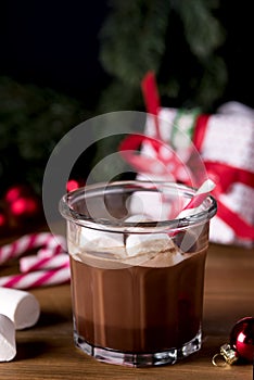 Close Up Homemade Tasty Hot Chocolate in Glass with Marshmallow Festive Christmas Background Candy Cane Vertical
