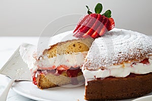 Close up of homemade Victoria sponge cake showing the filling