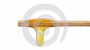 Close-up of Honey Dripping from Wooden Stick, Generative AI photo